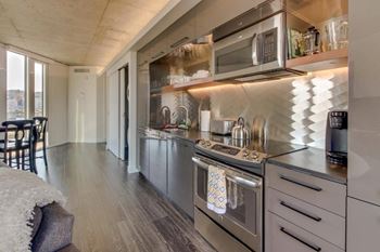 Yard apartments model kitchen with custom backsplash